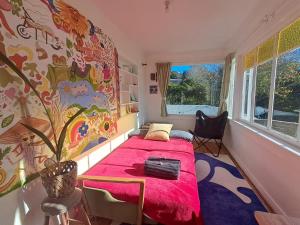 a bedroom with a bed with a pink blanket at Sunrays Stay - Stylish Retreat in New Plymouth +40 photos