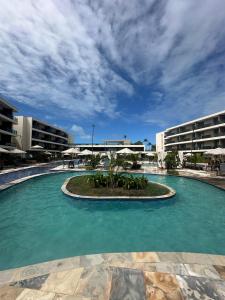 a large pool of water in front of a building at Flat Luxo 104A Malia em Muro Alto Porto de Galinhas in Ipojuca