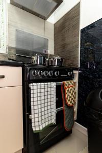 a stove with two pots and pans on it in a kitchen at 4 Bedroom House in Wolverhampton Sleeps 8 Ideal for Contractors in Fallings Park +16 photos