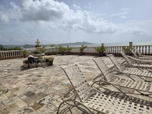 a group of chairs sitting on a patio with a fountain at Exotic Paradise Guest House in Yabucoa