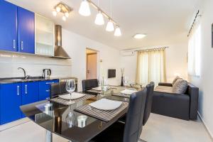 a kitchen and dining room with a table and chairs at Apartment Marko in Medulin