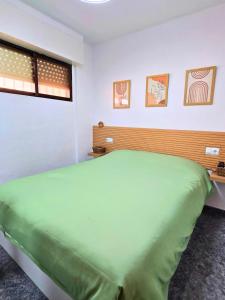 a bedroom with a large green bed in it at Sun & Playa 16 in Dehesa de Campoamor