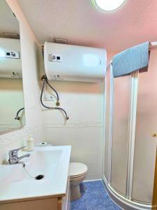 a bathroom with a toilet and a sink and a shower at Sun & Playa 16 in Dehesa de Campoamor +20 photos