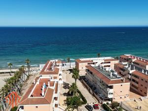 an aerial view of the beach and buildings at Sun & Playa 16 in Dehesa de Campoamor
