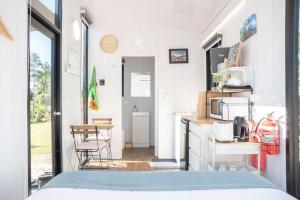 a room with a kitchen and a dining room at Sweet Retreat by Tiny Away in Bundaberg