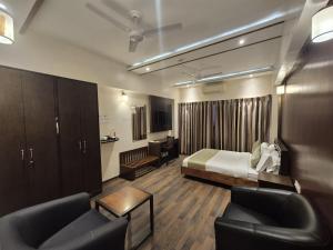 a hotel room with a bed and a desk at R D Hotels HSR in Bangalore