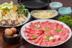 a table topped with plates of food and bowls of pasta at Wan Wan Paradise Tateshina in Tateshina +12 photos