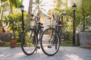 two bikes parked next to each other on a sidewalk at Baan Pila in Luang Prabang