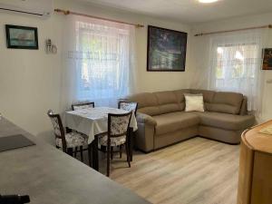 a living room with a couch and a table at Holiday Home Balatonbereny 16 in Balatonberény