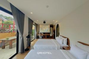Voodi või voodid majutusasutuse QR Hotel Dalat toas