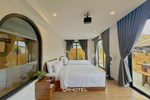 Voodi või voodid majutusasutuse QR Hotel Dalat toas