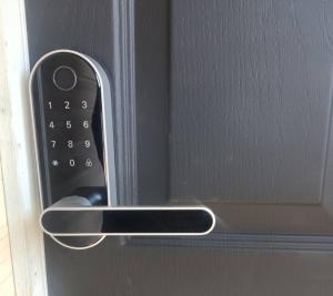 a close up of a remote control on a door at Guest House in McKees Rocks