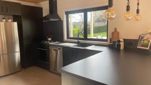 a kitchen with a counter and a sink and a window at On James in Coromandel Town
