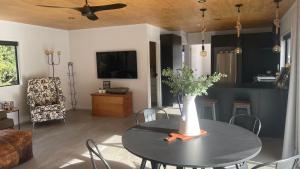 a living room with a table with a vase on it at On James in Coromandel Town