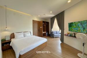 Voodi või voodid majutusasutuse QR Hotel Dalat toas +37 fotot