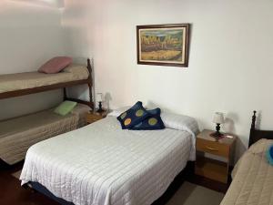 a bedroom with two twin beds and a picture on the wall at Like home 2 in Salta