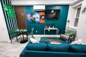 a living room with a blue couch and a table at Perch in Paradise EaglesThemed Escape in Philadelphia