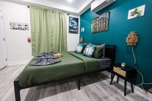 a bed in a room with a blue wall at Perch in Paradise EaglesThemed Escape in Philadelphia