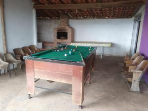 a pool table in a room with a pool table at Sítio Topo do Vale in Sabará