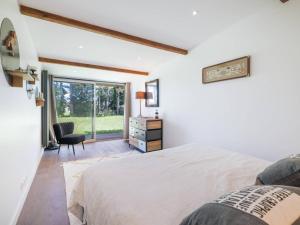 une chambre avec un lit, une chaise et une fenêtre dans l'établissement Maison spacieuse avec jardin et animaux admis - FR-1-821-42, à Le Touquet-Paris-Plage