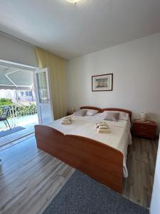 a bedroom with a large bed with towels on it at Korčula Guest House in Korčula +17 photos