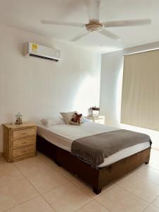 a dog laying on a bed in a bedroom at Puerto Azul in Puerto Colombia