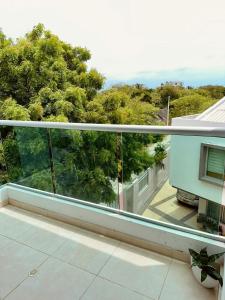 a balcony with a view of trees on a house at Puerto Azul in Puerto Colombia