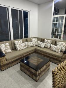 a living room with a couch and a coffee table at Mountain house with a view and private pool in Estación El Salto