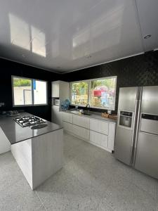 a kitchen with a stainless steel refrigerator and a stove at Mountain house with a view and private pool in Estación El Salto +31 photos