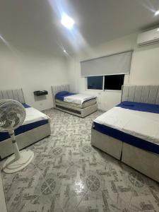 a bedroom with two beds and a table in it at Mountain house with a view and private pool in Estación El Salto