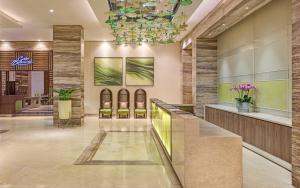 a lobby of a hotel with a chandelier at Belmont Hotel Manila near NAIA Terminal 3 MNL in Manila