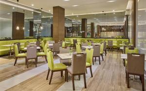 a dining room with tables and chairs in a restaurant at Belmont Hotel Manila near NAIA Terminal 3 MNL in Manila