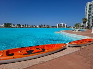 two kayaks are parked next to the water at Apartamento Fina Dream Lagoon in Veracruz