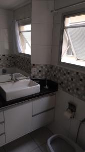 a bathroom with a sink and a tub and a toilet at 2 bedrooms 2 bathrooms shopp beach wifi in Vila Velha