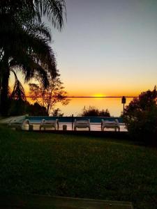 a group of cars parked next to the water at sunset at Del Barranco in San Gregorio de Polanco