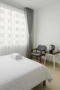 Postel nebo postele na pokoji v ubytování Amory Hotel Saigon Center