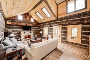 a living room with a couch and a fireplace at Private 4 acre waterfront cabin with Hot Tub in Morgantown