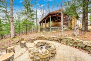 a fire pit in front of a log cabin at Private 4 acre waterfront cabin with Hot Tub in Morgantown
