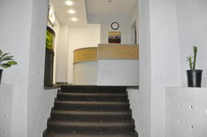 a staircase in a house with a clock on the wall at Hostel Olimpiya in Moscow