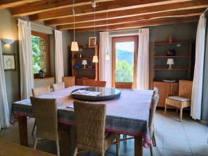 a dining room with a table and some chairs at La Bastide en Cévennes in Saint-Hilaire-de-Lavit