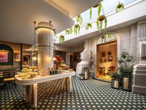 a lobby with a table and chairs in a building at Grand Madison Wuhan Hankou on the Bund in Wuhan