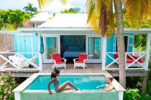 two women sitting in the swimming pool of a villa at Cocobay Resort Antigua - All Inclusive - Adults Only in Johnsons Point