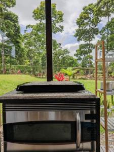 a stove top oven sitting on top of a table at Tropical Crystal House in Guápiles