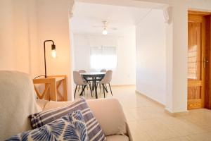 a living room with a couch and a table at Soleado adosado esquinero frente a piscina in Gran Alacant