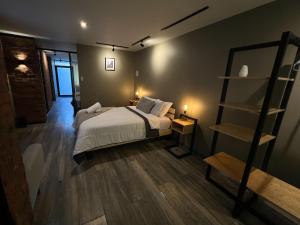 a bedroom with a bed and a book shelf at Solar Deluxe Arequipa in Arequipa