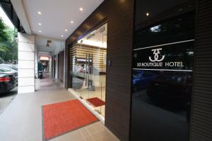 a building with a sign on the door of a store at 33 Boutique Hotel Bandar Sunway in Petaling Jaya