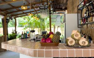 a kitchen counter with a basket of fruit on it at The Summer House Samui in Choeng Mon Beach
