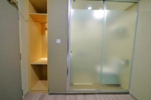 a glass shower in a walk in closet at 33 Boutique Hotel Bandar Sunway in Petaling Jaya