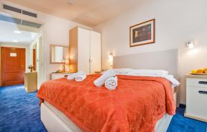Postel nebo postele na pokoji v ubytování Hotel Dubrovnik