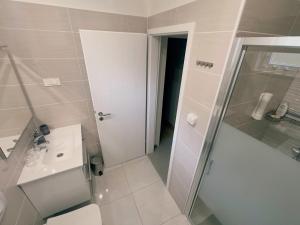a bathroom with a shower and a toilet and a sink at Apartmani Lamat in Tribalj +22 photos